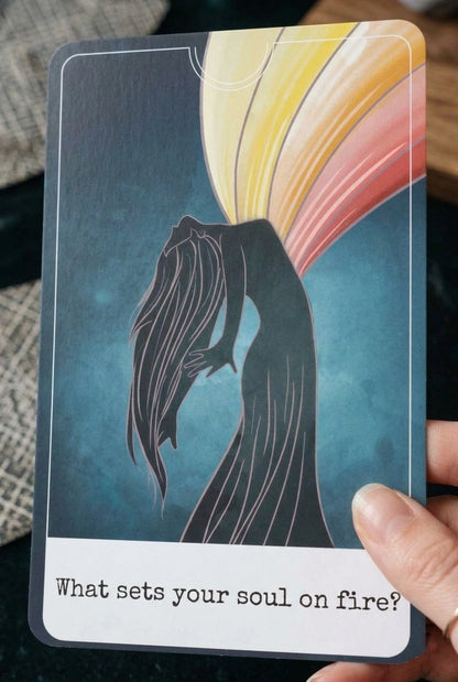 Card with silhouette of a person and colorful abstract design, asking 'What sets your soul on fire?'